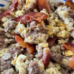 Cooked carnivore scramble with beef, bacon, eggs, and butter served in a bowl.