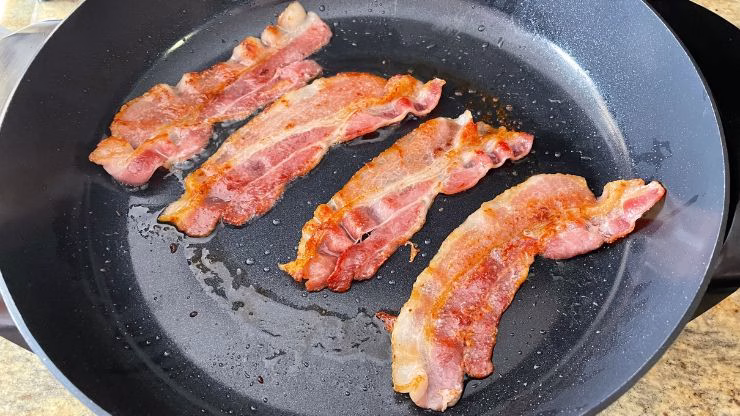 Cooking bacon in a skillet to render fat for carnivore scrambled eggs