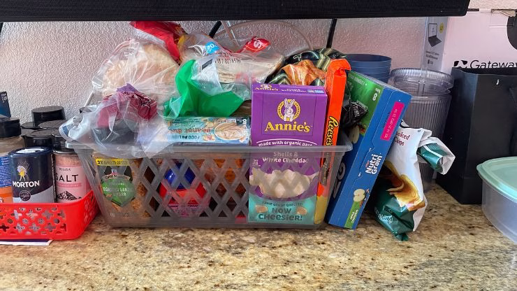 Basket of non-carnivore foods kept separately in a hotel room for partner’s snacks and meals